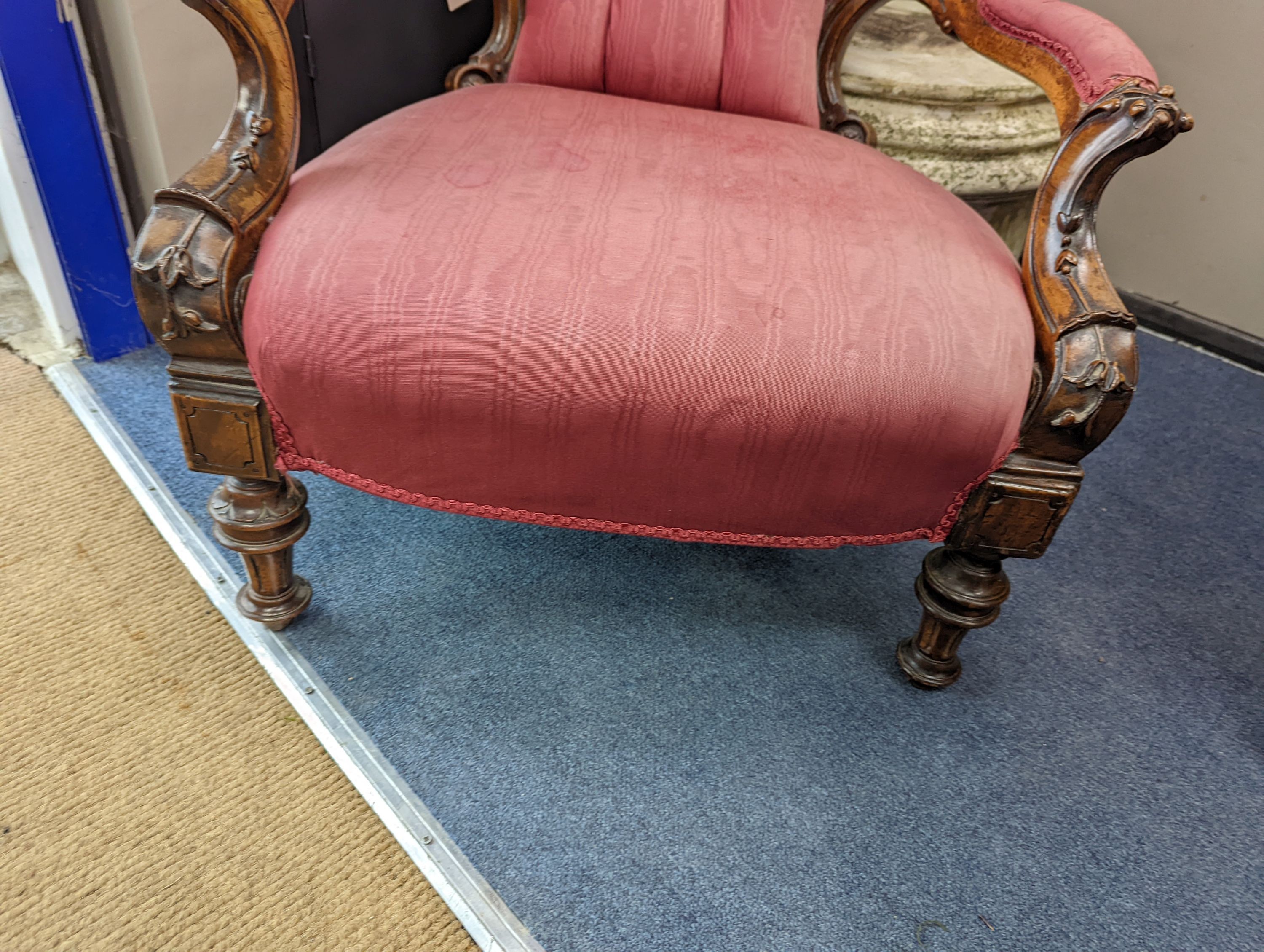 A Victorian carved walnut open armchair